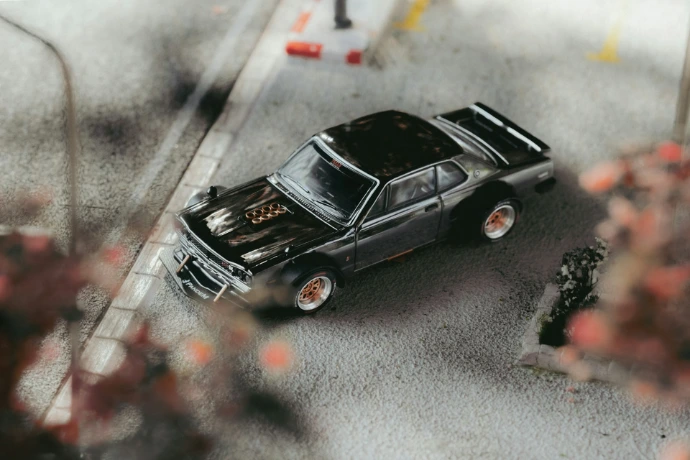 A toy car is parked on the side of the road